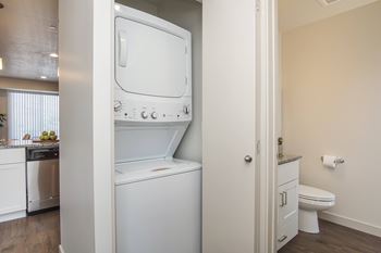 A white washing machine and dryer in a small laundry room.